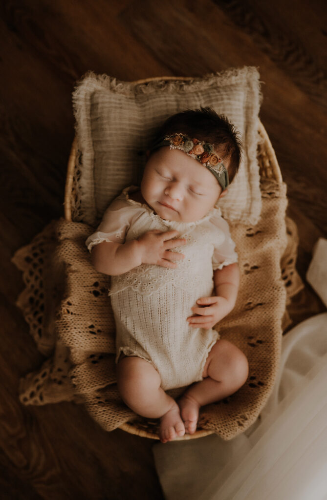 Dallas newborn baby laying in bassinet in Dallas studio 