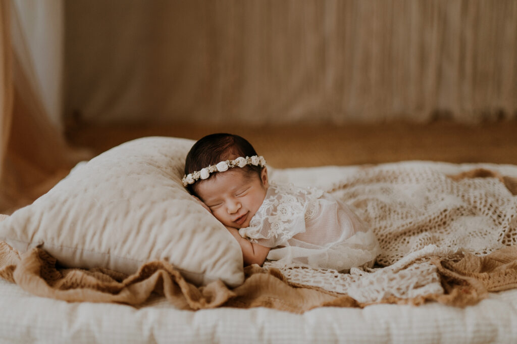 Dallas newborn baby in studio snuggling on a pillow 
