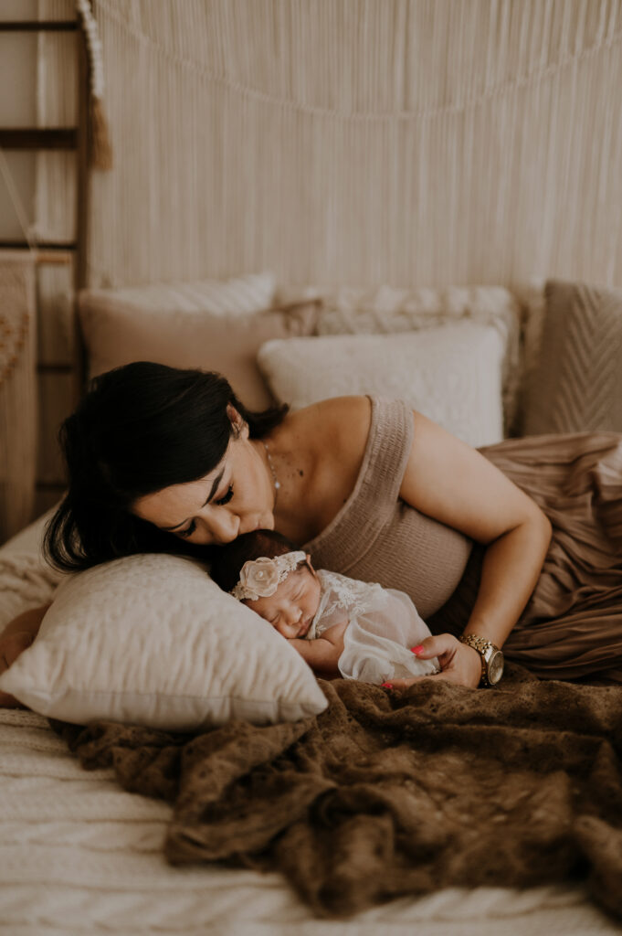 Dallas mom snuggling with her newborn baby in my photography studio 