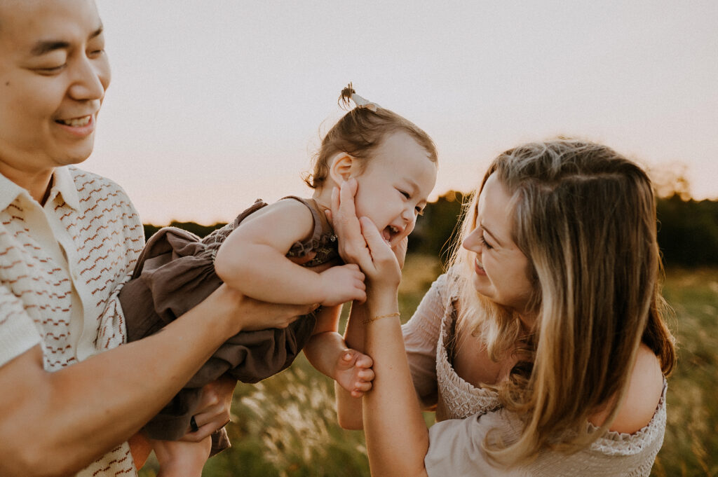 Family of three in Dallas Texas smiling and having fun.