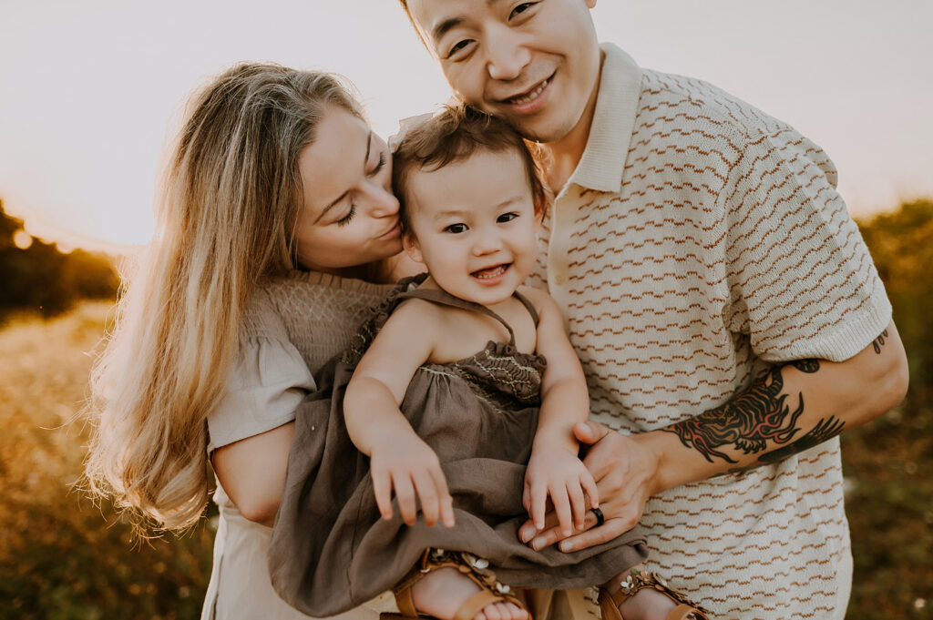 Family of three cuddled up in Dallas TX.