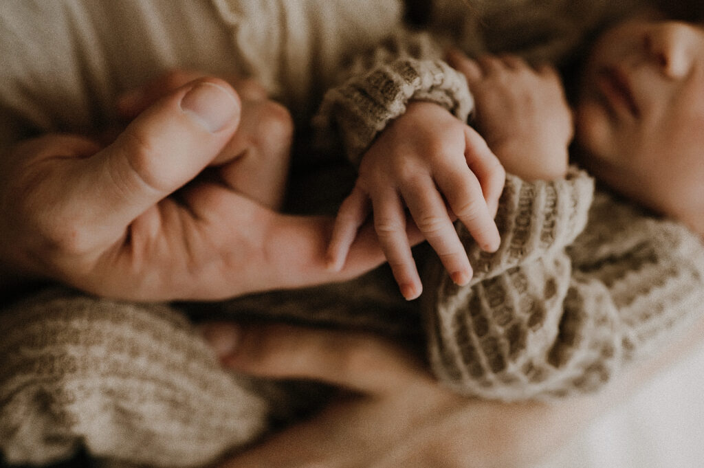 dad holding baby's hand in Dallas studio