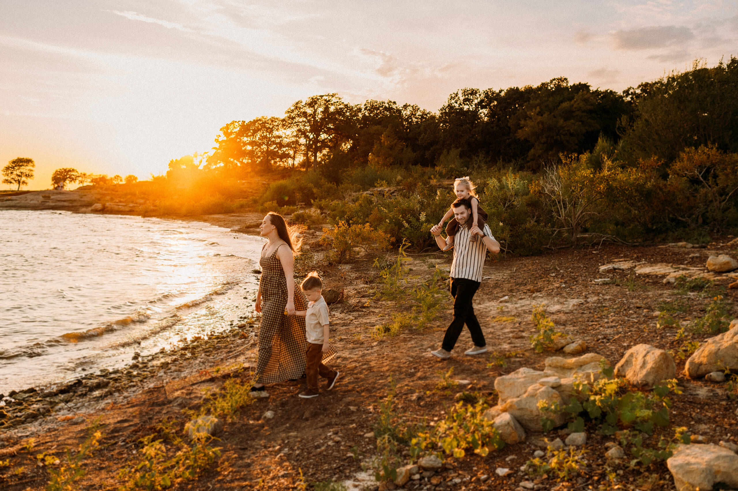 A family of fort walking along the shores of grapevine lake in dallas, tx
